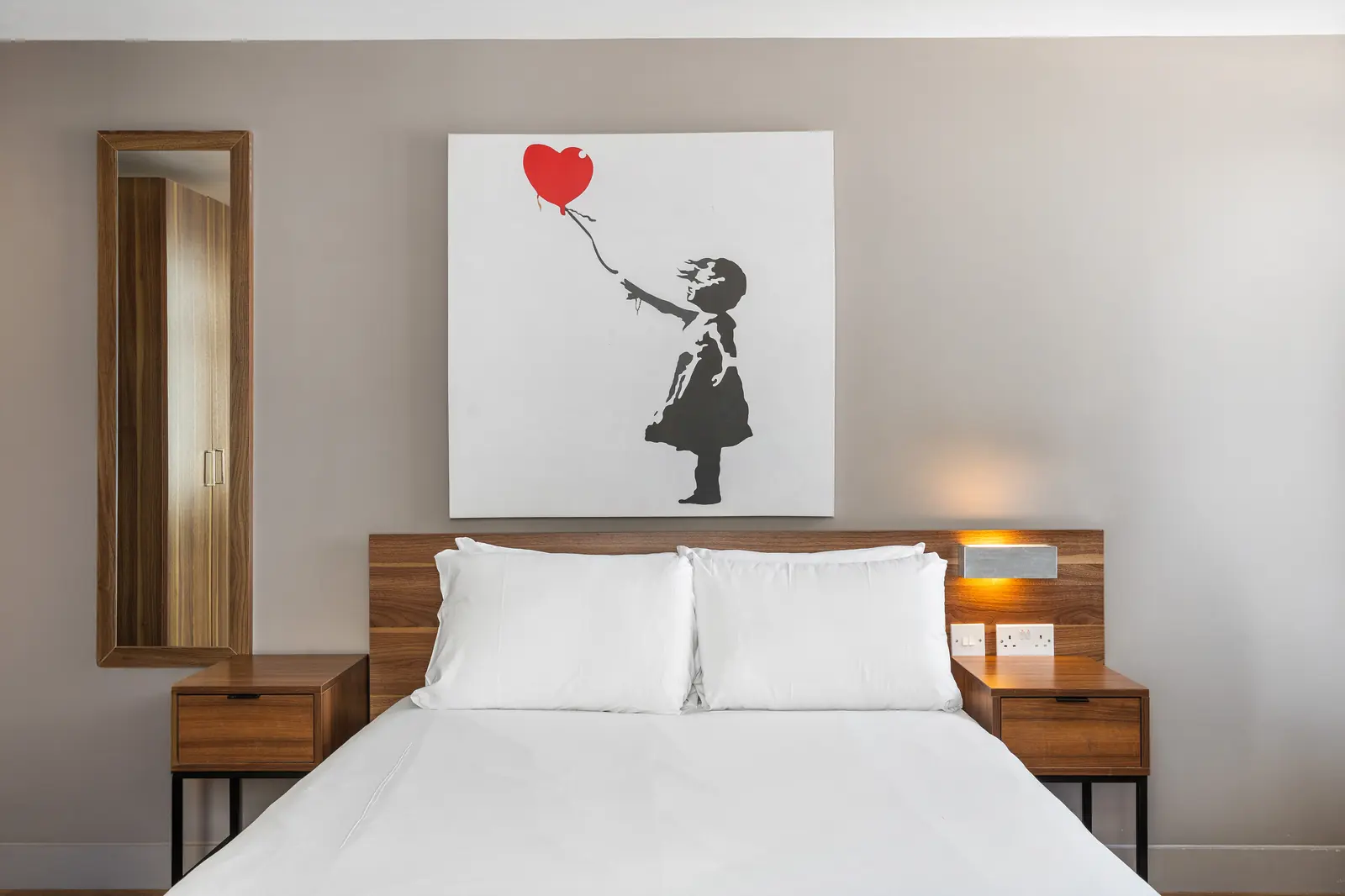 Double bed with Banksy-style artwork