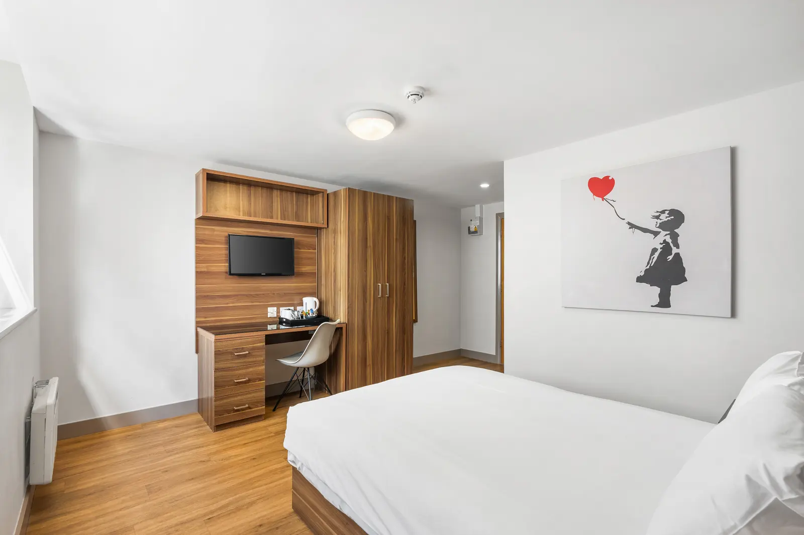 Standard Double Room with double bed and Banksy-style artwork